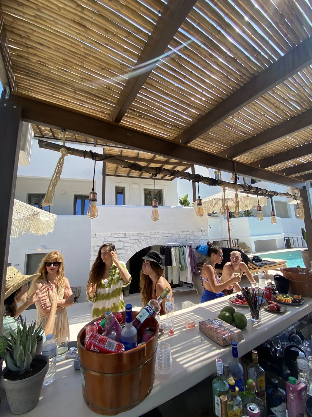 Pool bar at a Greek hotel — bamboo pergola, daytime activation