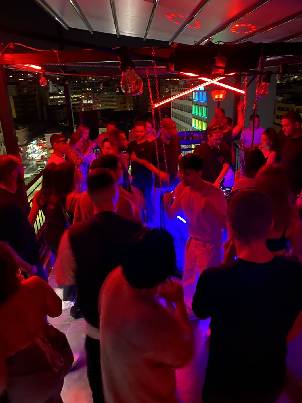 Rooftop event — Athens night skyline with red neon