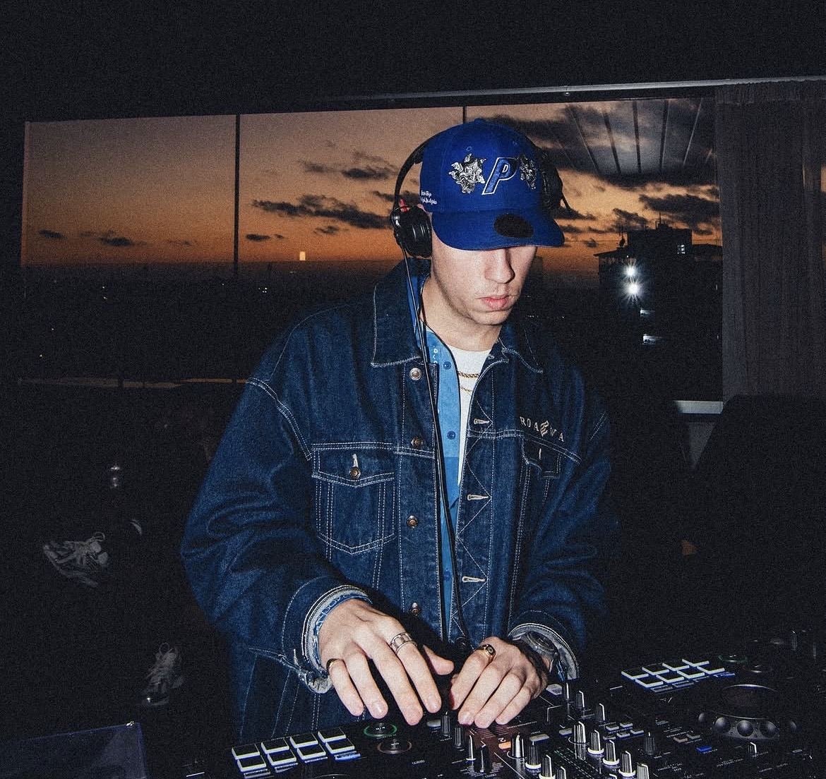 DJ at sunset — denim jacket, headphones, dusk over Athens